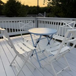 Metal table set with four chairs.