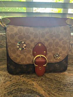 Authentic monogram coach bag with attached coach pins