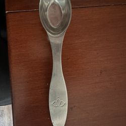 This vintage-style spoon is a Gevalia 18/10 stainless steel coffee scoop, featuring a unique logo engraved on the handle.