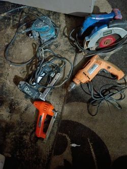 A Few Different Kinds And A Few Different Brands Of Corded Power Tools A Drill A Stapler A Sander And Skill Saw