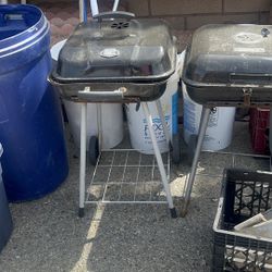 two small charcoal grills 