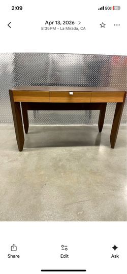 mid-century modern or contemporary style writing desk or console table featuring a distinctive multi-toned wood construction.