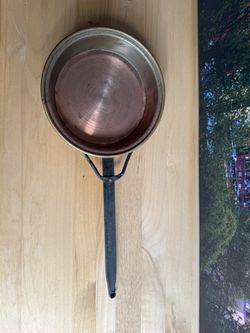 antique copper frying pan, probably made in France, with a long wrought-iron riveted handle, intended for cooking in a fireplace.