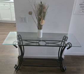 Nice good condition wrought iron table with glass top.