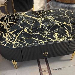  Modern Coﬀee Table LOOK UP A contemporary oval coﬀee table with a black and gold marble- eﬀect top. TIME PERIOD Contemporary ORIGIN Unknown ESTIMATED