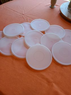 12 Tupperware lids, 6+ inches circumference.