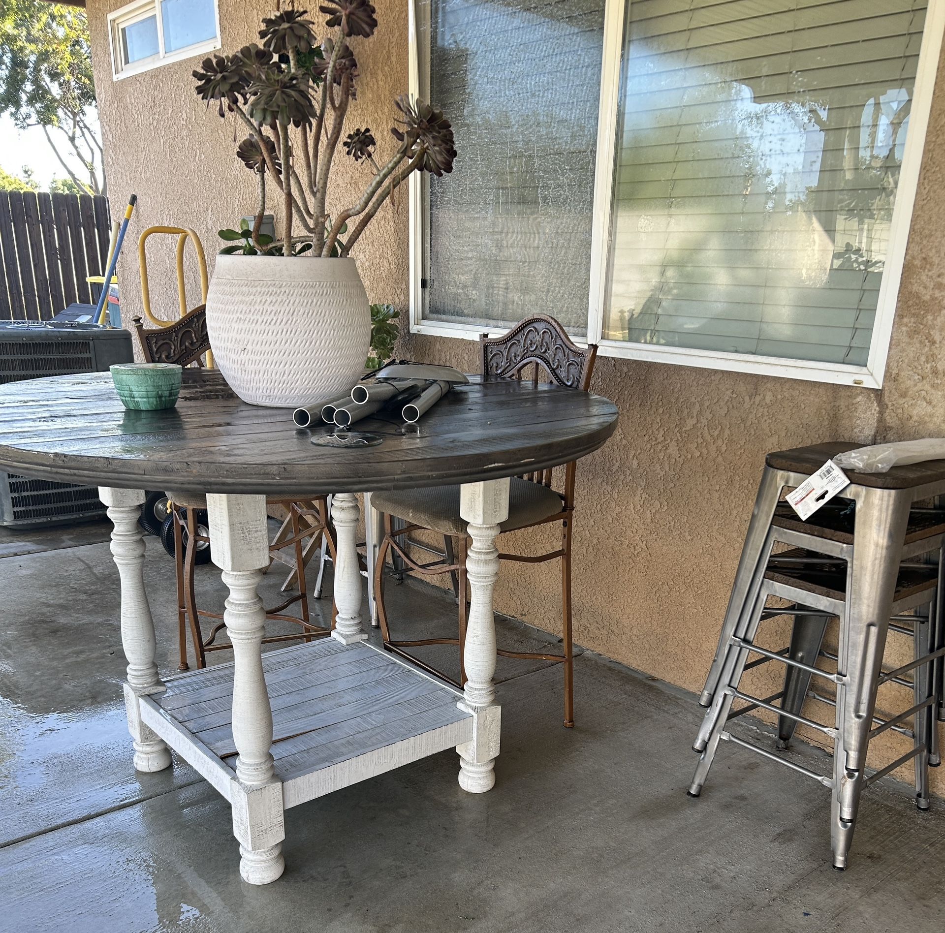 $150 takes table 2 high chairs & 4 bar stools firm