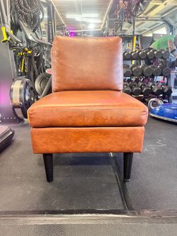 Faux leather slipper chair.