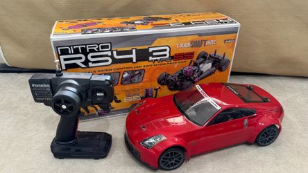 "Rare vintage HPI Racing Nitro RS4 3 Type SS 1/10 4WD Nissan 350Z. Complete with original box and Futaba transmitter. Excellent collector condition. H