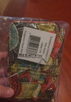 Vera Bradley smart phone wristlet with snap closure for phone, ID window, zip around pouch to hold cash and cards
