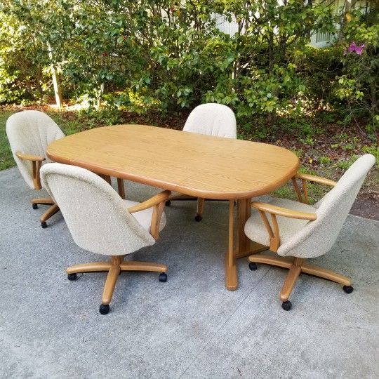 Expanding Dining Table with 4 Rolling Chairs and 2 Leaves