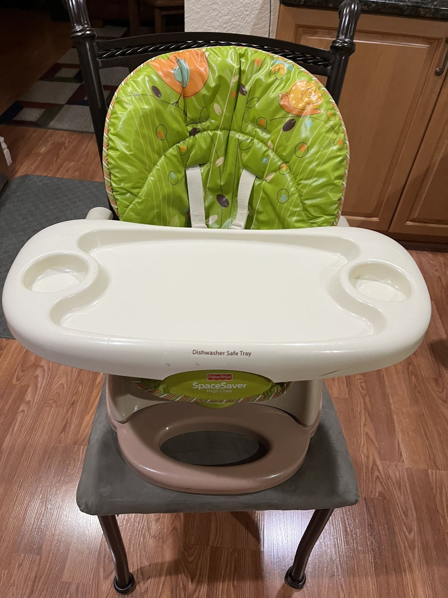Fisher-Price SpaceSaver High Chair. This compact high chair is designed to strap securely onto most standard dining chairs