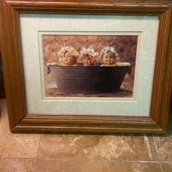 This item is a framed print titled "Washtub" featuring photography by Anne Geddes.     It depicts thr