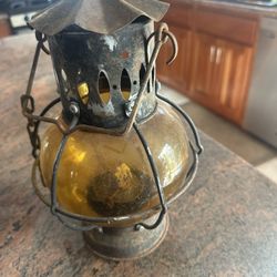 Rustic metal and glass lantern, perfect for home decor.