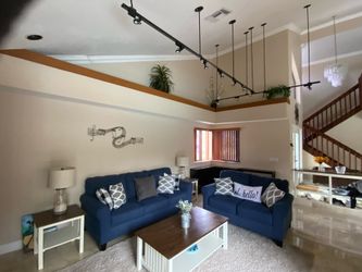 Blue couch and loveseat