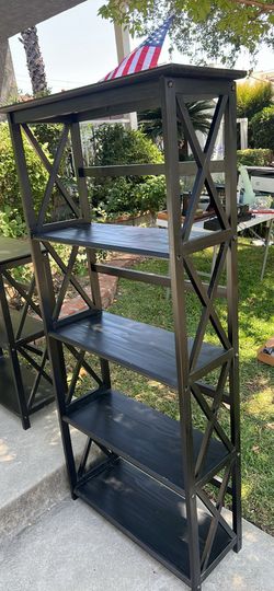 Black wooden bookshelf with cross cross pattern