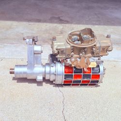 Vintage MagnaCharger supercharger assembly with Holley carburetor and drive/snount assembly.