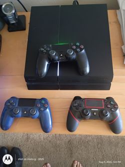 PS4 console with three controllers