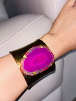 wide brass cuff bracelet with a bright pink agate slice