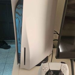 PS5 with controller and charging base