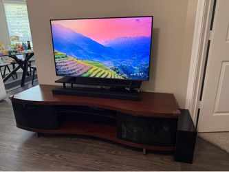 Modern multimedia stand with glass and shelves. TV and soundbar not included.