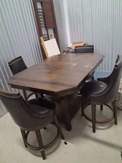 Wooden table with expansion gears to make it bigger used and seats are also in used shape wear and tear visible,