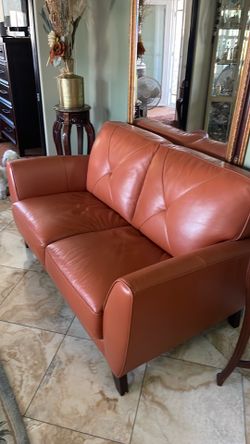 Burnt orange leather love seat