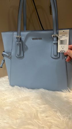 This is a Michael Kors Voyager Large Saffiano Leather EW Tote Shoulder Bag in the color Light Sky.