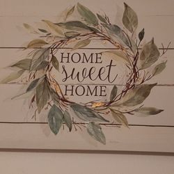 Decorative wall art with 'Home Sweet Home' text 