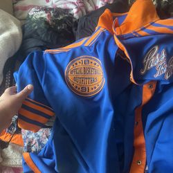 This is a New York Knicks blue and orange varsity jacket. 
