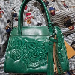 Patricia Nash Paris Satchel is crafted from soft green tooled leather featuring a vintage-inspired floral design. 