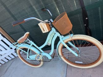 Mint  green Huffy bicycle Nel Lusso Girls' Cruiser Bike with 24-inch wheels.