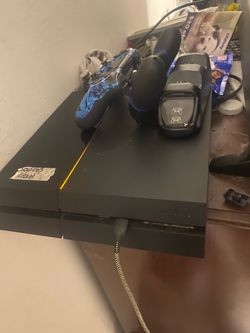 PlayStation 4 with 2 controllers and charging deck (cords included)