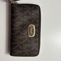 Michael Kors Jet Set Travel Continental Wallet in brown monogram coated canvas.