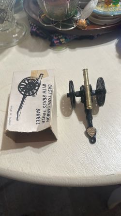 Cast iron miniature with brass finish barrel