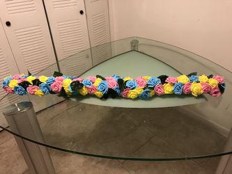 Fake floral garland roses pink blue yellow used for gender reveal