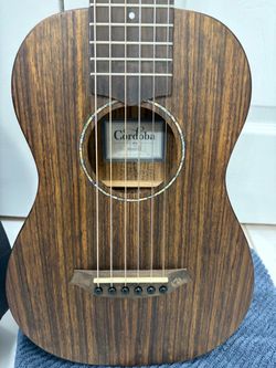 Classic guitar Cordoba Mini-O Nylon strings , with case .