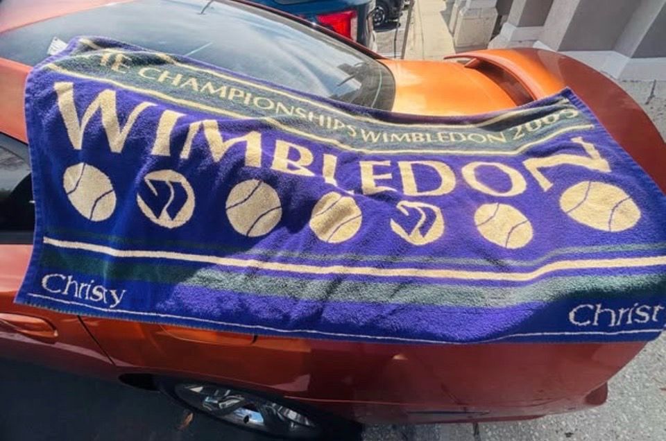 Vintage Christy Wimbledon 2009 commemorative bath towel in purple and green. The image shows a purple, yellow, and green striped pattern, which corre