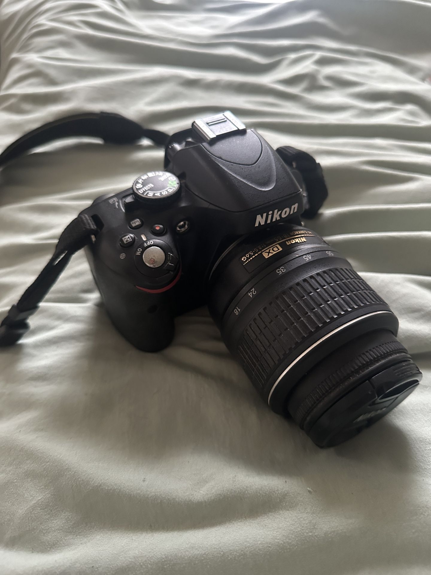 Nikon D5100 DSLR camera equipped with an AF-S DX Nikkor 18-55mm lens