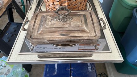 This is a vintage silver-plated buffet server and casserole holder featuring ornate handles, decorative feet, and a matching lid.