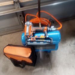 4 gallon air compressor with new brad nailer and hose