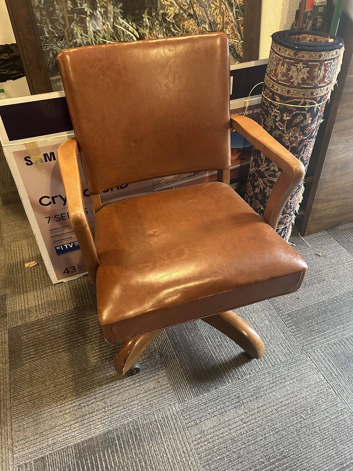 Vintage leather and wood office chair on wheels