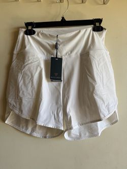 Golf white shorts with a smooth, high-rise waistband for comfort. Lightweight, breathable fabric designed for movement