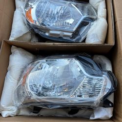 New 2015 Toyota Tacoma headlights fits 2012 to 2015 asking $175
