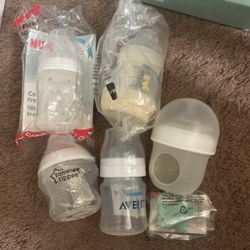 Five Different Baby Bottles And Travel Bug Pacifier Holder