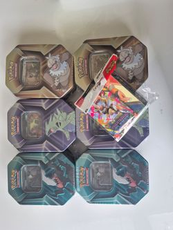 6 Pokemon tripple Whammy tins + phantasmal flames booster pack and portfolio