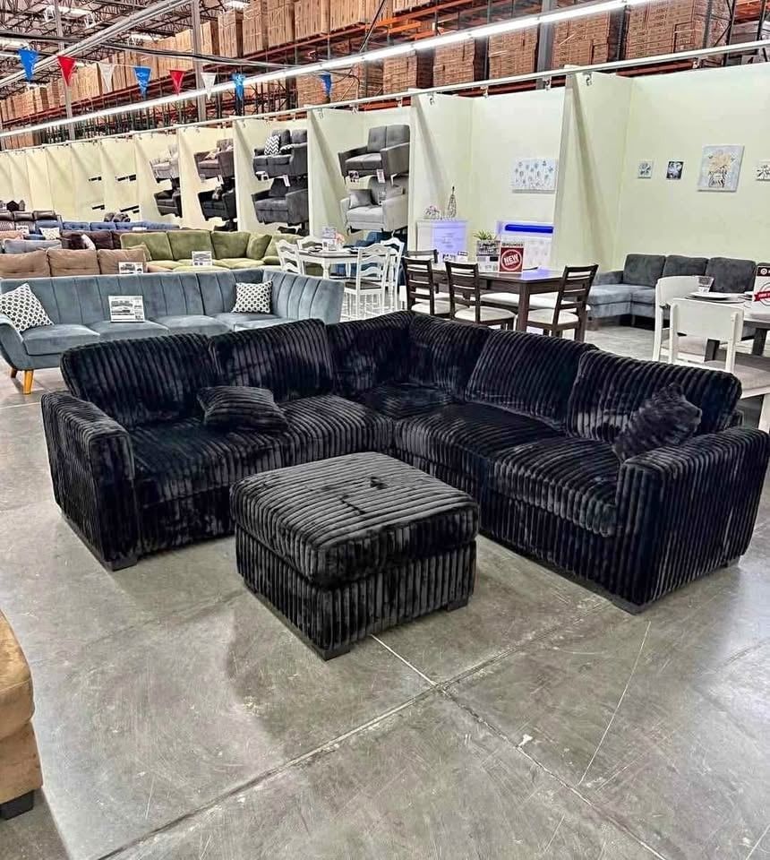 Black jumbo corduroy sectional sofa with ottoman