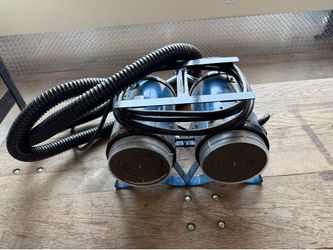 Professional-grade high velocity dog grooming dryer is manufactured by Electric Cleaner Co. This blue K-9 III model has a dual-motor design with a met