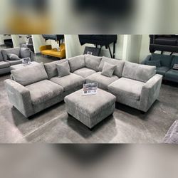 Gray corduroy sectional sofa with ottoman