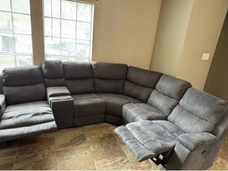 Grey sectional seats five people.